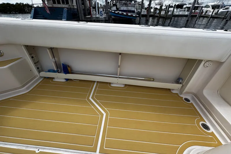  Yacht Photos Pics 2001 Grady-White Express 330 boat interior with teak flooring and storage compartment.