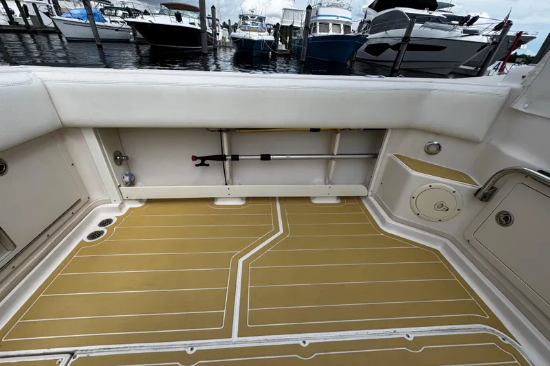  Yacht Photos Pics 2001 Grady-White Express 330 boat interior with tan deck and rod storage.
