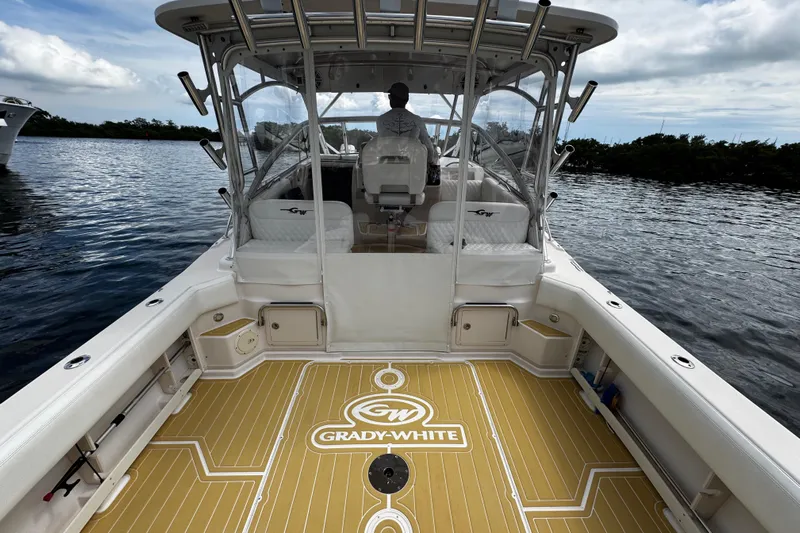  Yacht Photos Pics 2001 Grady-White Express 330 boat on water, featuring spacious deck and seating.