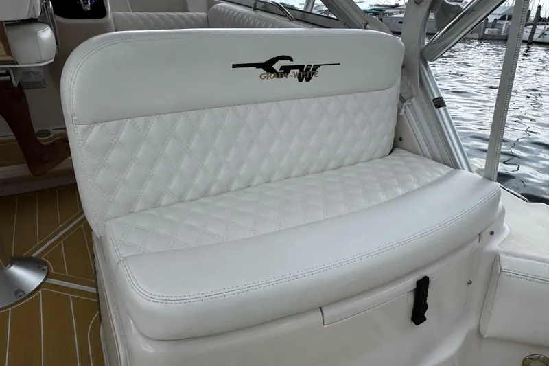  Yacht Photos Pics Luxurious seating on 2001 Grady-White Express 330 boat, featuring quilted white upholstery.