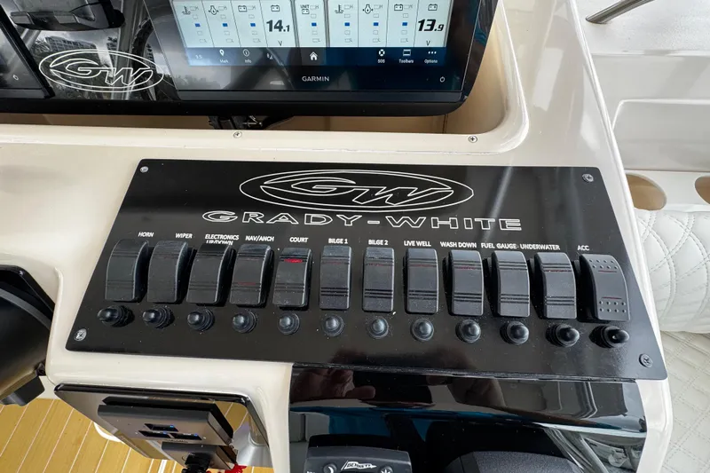  Yacht Photos Pics Control panel of a 2001 Grady-White Express 330 boat with switches and Garmin display.