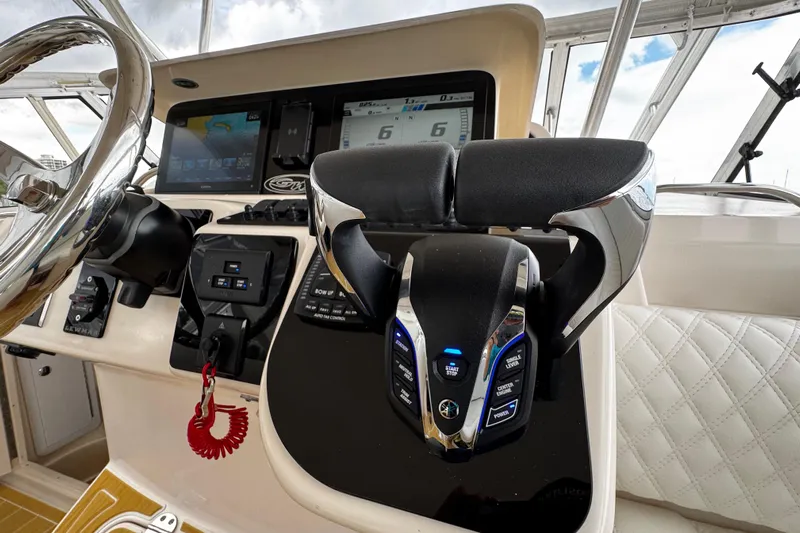  Yacht Photos Pics Control panel of 2001 Grady-White Express 330 boat with steering wheel and throttle levers.