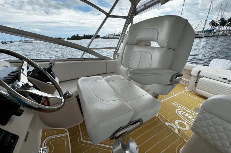  Yacht Photos Pics Luxurious 2001 Grady-White Express 330 boat interior with white leather seating and scenic marina view.