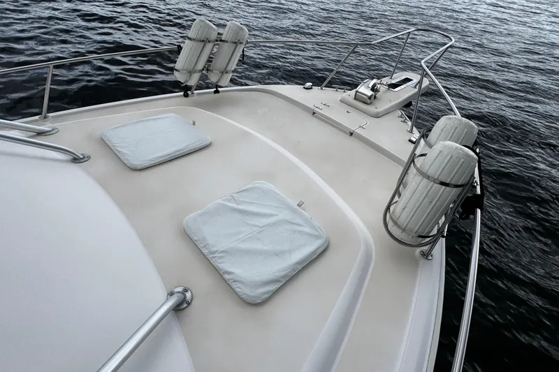  Yacht Photos Pics 2001 Grady-White Express 330 boat deck with cushions and railing on the water.