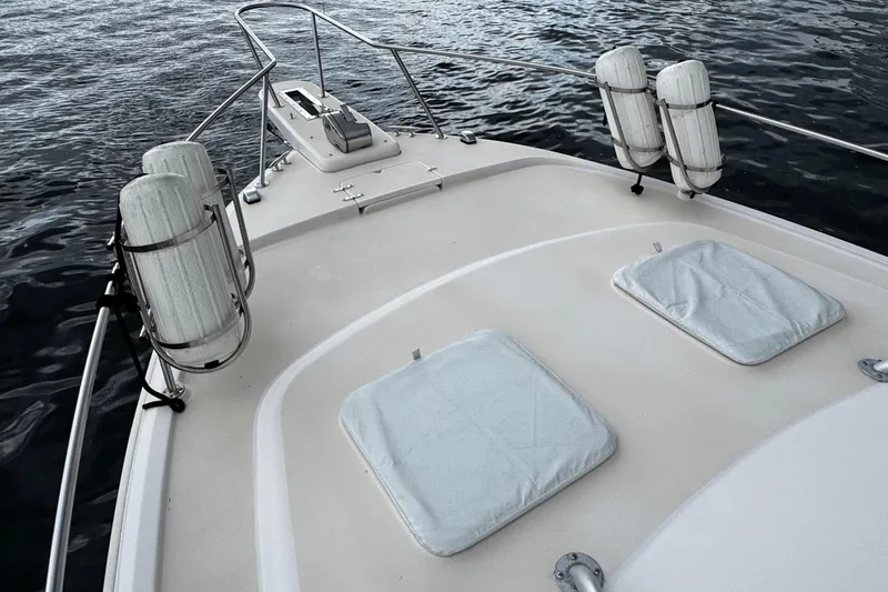  Yacht Photos Pics Bow view of 2001 Grady-White Express 330 boat with fenders and hatches.