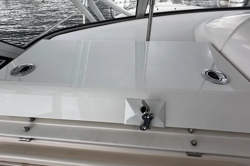  Yacht Photos Pics 2001 Grady-White Express 330 boat deck with storage compartment and lock.