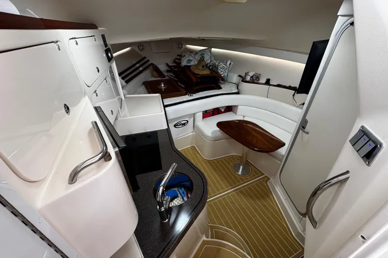 Yacht Photos Pics 2001 Grady-White Express 330 cabin interior with kitchenette, seating, and wooden table.