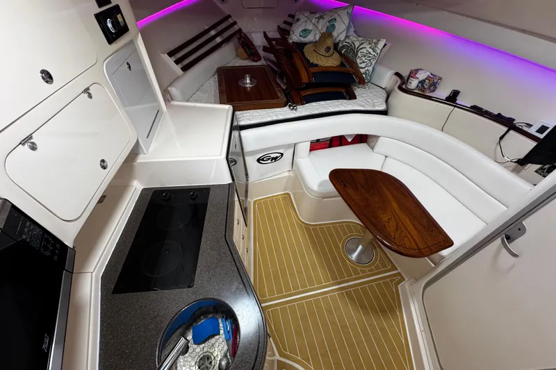  Yacht Photos Pics 2001 Grady-White Express 330 cabin interior with kitchenette, seating, and ambient lighting.