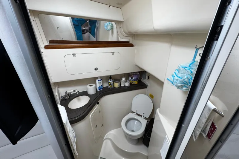  Yacht Photos Pics 2001 Grady-White Express 330 boat bathroom with sink, toilet, and storage.