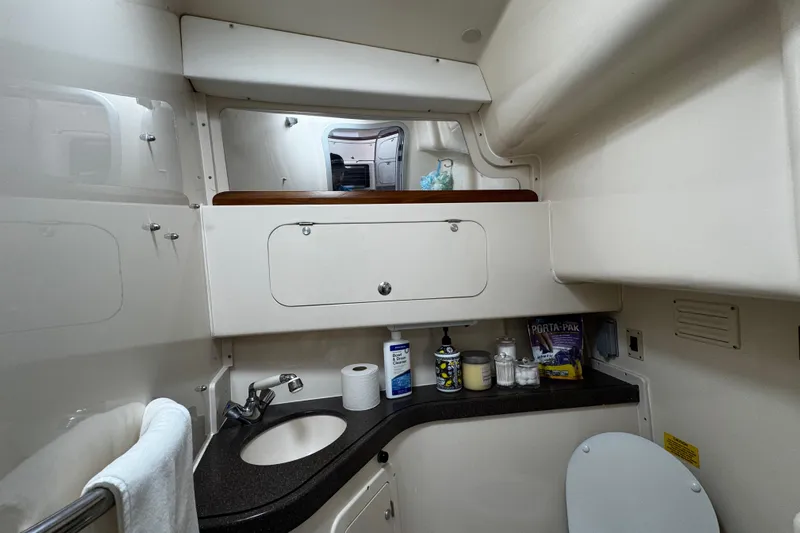  Yacht Photos Pics 2001 Grady-White Express 330 boat bathroom with sink, storage, and toiletries.