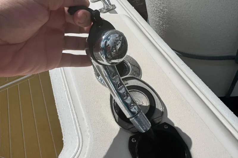 Yacht Photos Pics Hand holding a chrome lever on a 2001 Grady-White Express 330 boat deck.