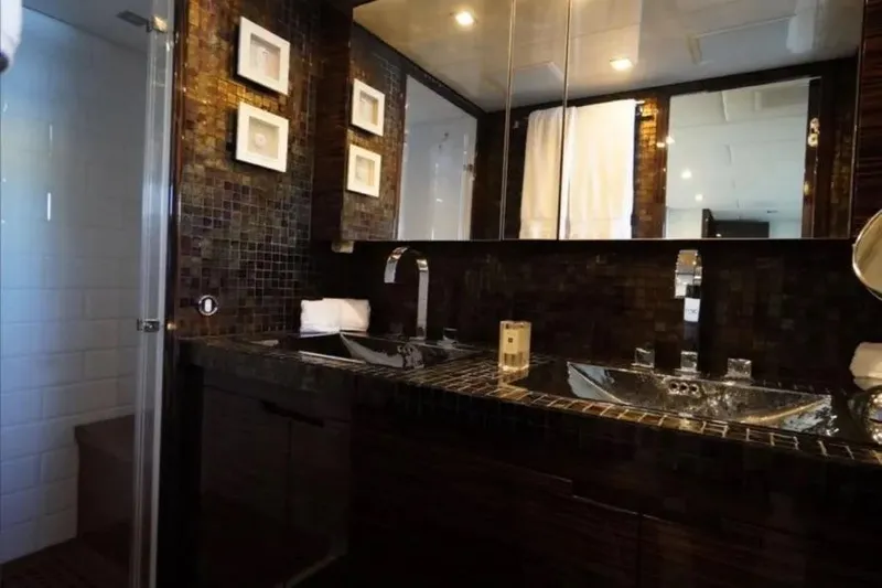  Yacht Photos Pics Luxurious bathroom with dual sinks, mosaic tiles, and modern fixtures on Leopard 112 yacht.