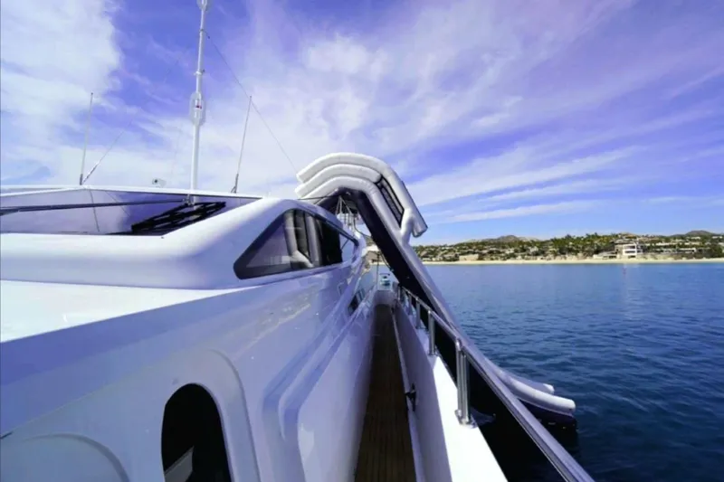  Yacht Photos Pics Luxury yacht Leopard 112 (2008) with water slide, cruising near scenic coastline.