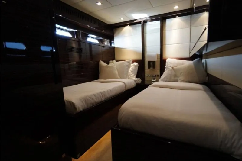  Yacht Photos Pics Luxurious twin cabin interior on 2008 Leopard 112 yacht, featuring elegant bedding and ambient lighting.