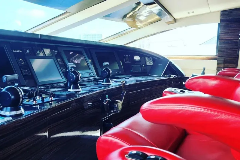  Yacht Photos Pics Luxurious Leopard 112 yacht cockpit with red leather seats and advanced navigation controls, 2008 model.