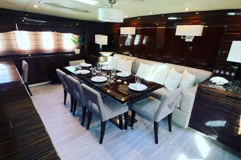  Yacht Photos Pics Luxurious dining area on a 2008 Leopard 112 yacht, featuring elegant table settings and plush seating.