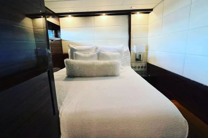  Yacht Photos Pics Luxurious bedroom interior in a 2008 Leopard 112 yacht, featuring elegant bedding and modern design.