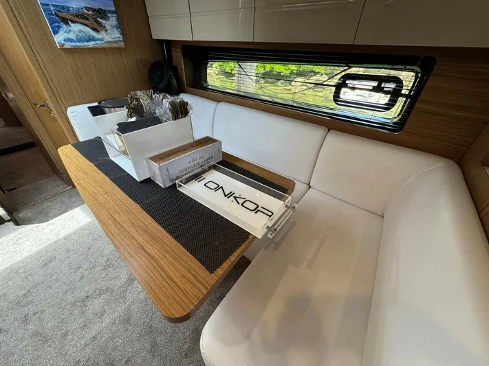 Onkor II Yacht Photos Pics Interior of 2015 Azimut Atlantis 43 yacht with modern seating and wooden table.
