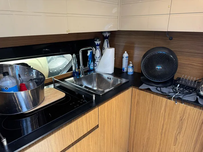 Onkor II Yacht Photos Pics Kitchen area of 2015 Azimut Atlantis 43 yacht with sink and appliances.