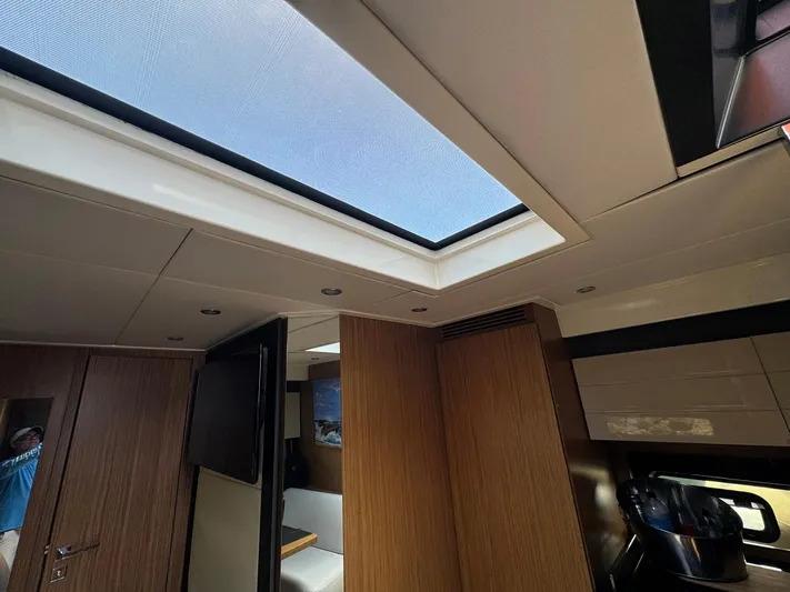 Onkor II Yacht Photos Pics Interior view of 2015 Azimut Atlantis 43 yacht with skylight and modern wood paneling.