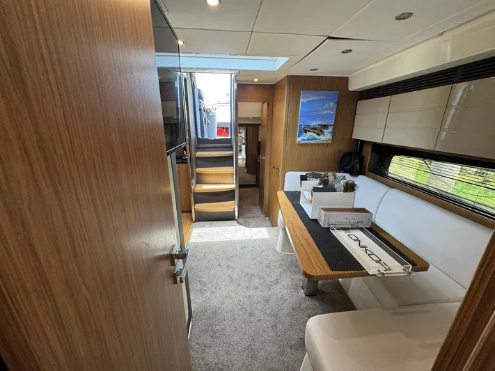 Onkor II Yacht Photos Pics Interior of 2015 Azimut Atlantis 43 yacht with modern dining area and wooden finishes.