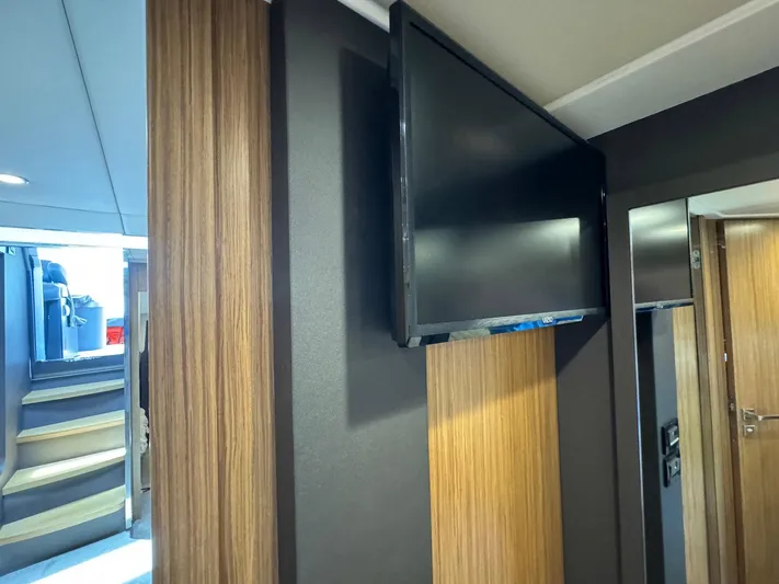 Onkor II Yacht Photos Pics Interior of 2015 Azimut Atlantis 43 yacht with mounted TV and wooden paneling.