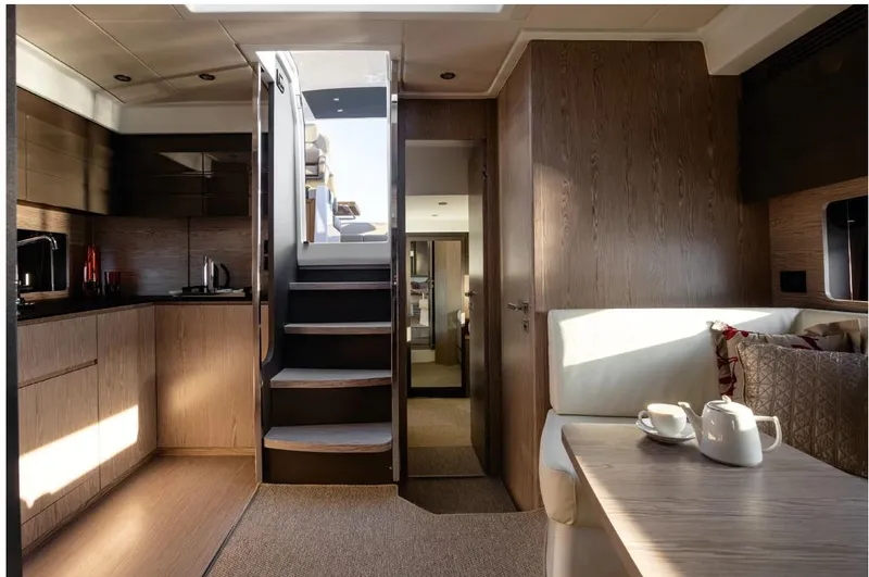 Onkor II Yacht Photos Pics Luxurious interior of 2015 Azimut Atlantis 43 yacht with modern kitchen and cozy seating area.