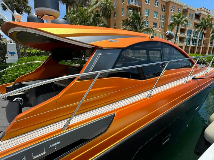 Onkor II Yacht Photos Pics Orange 2015 Azimut Atlantis 43 yacht docked near luxury apartments.