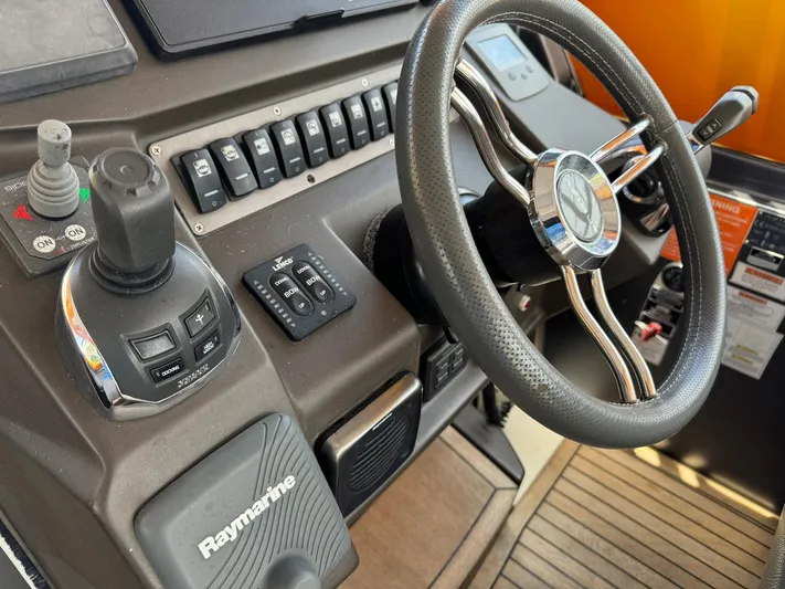 Onkor II Yacht Photos Pics Control panel of a 2015 Azimut Atlantis 43 yacht with steering wheel and navigation controls.