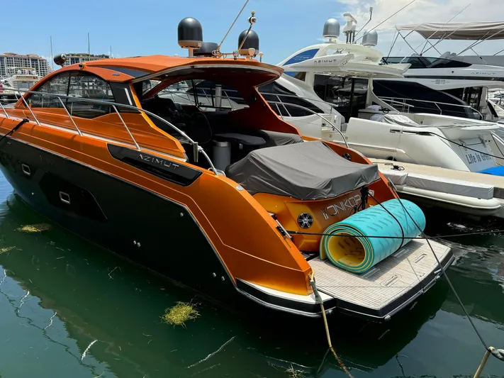 Onkor II Yacht Photos Pics Azimut Atlantis 43 yacht, 2015 model, docked with vibrant orange exterior.