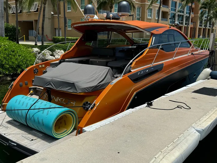 Onkor II Yacht Photos Pics 2015 Azimut Atlantis 43 yacht docked, featuring sleek orange design and outdoor seating.