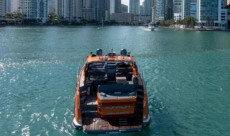 Onkor II Yacht Photos Pics 2015 Azimut Atlantis 43 yacht cruising in urban waterway with city skyline.