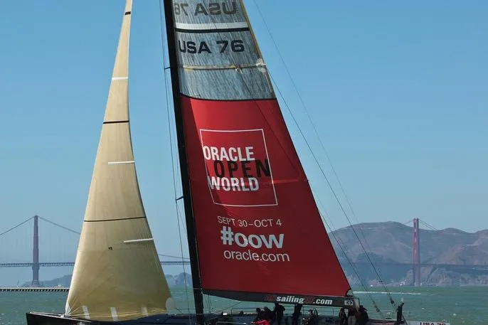 Sailboat "USA 76" with Oracle branding, Golden Gate Bridge in background, 2002 International Americas Cup Class.