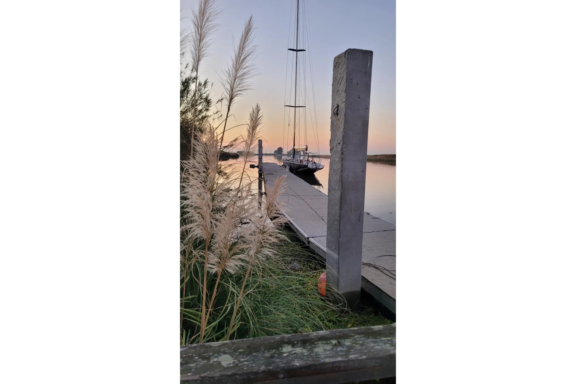 Sailboat docked at sunset, Custom International Americas Cup Class, 2002.