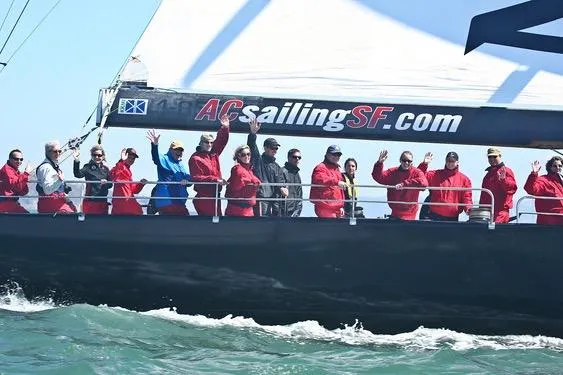 Group sailing on 2002 Custom International Americas Cup Class yacht, ACsailingSF.com, in open waters.