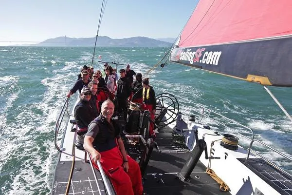 Sailing crew on 2002 Custom International Americas Cup Class yacht in open sea.