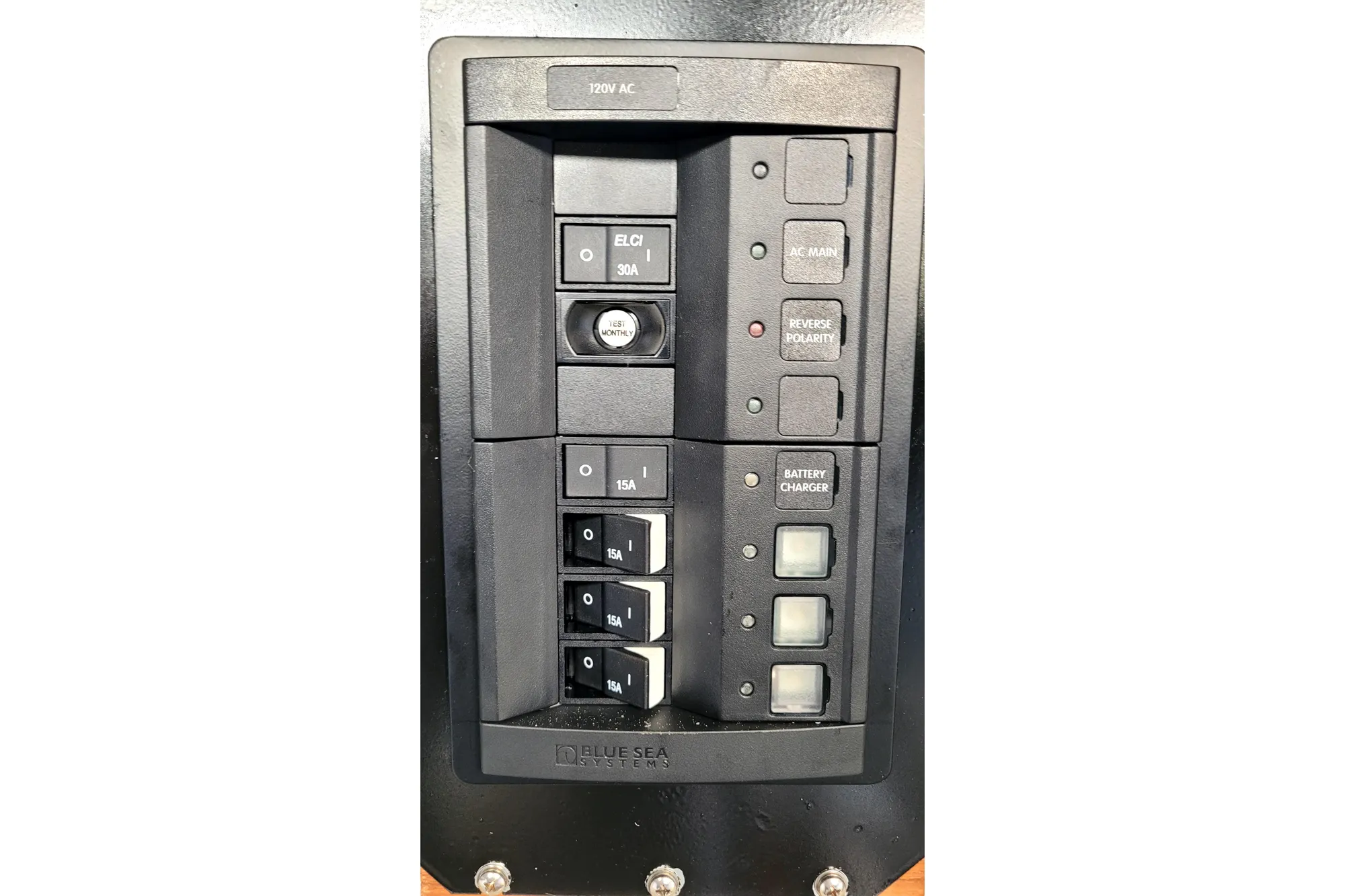 Electrical panel with switches and indicators on a 2002 Custom International Americas Cup Class boat.