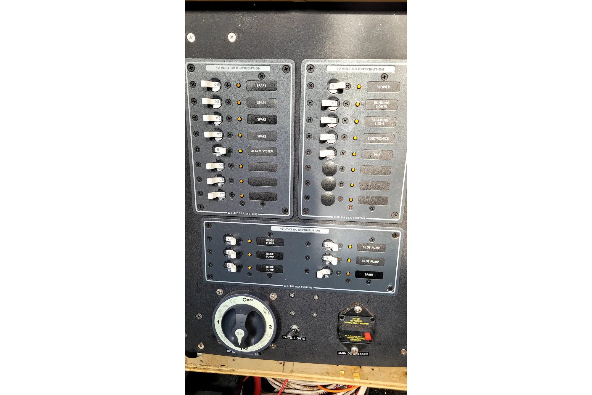 Control panel of a 2002 Custom International Americas Cup Class yacht, featuring switches and dials.