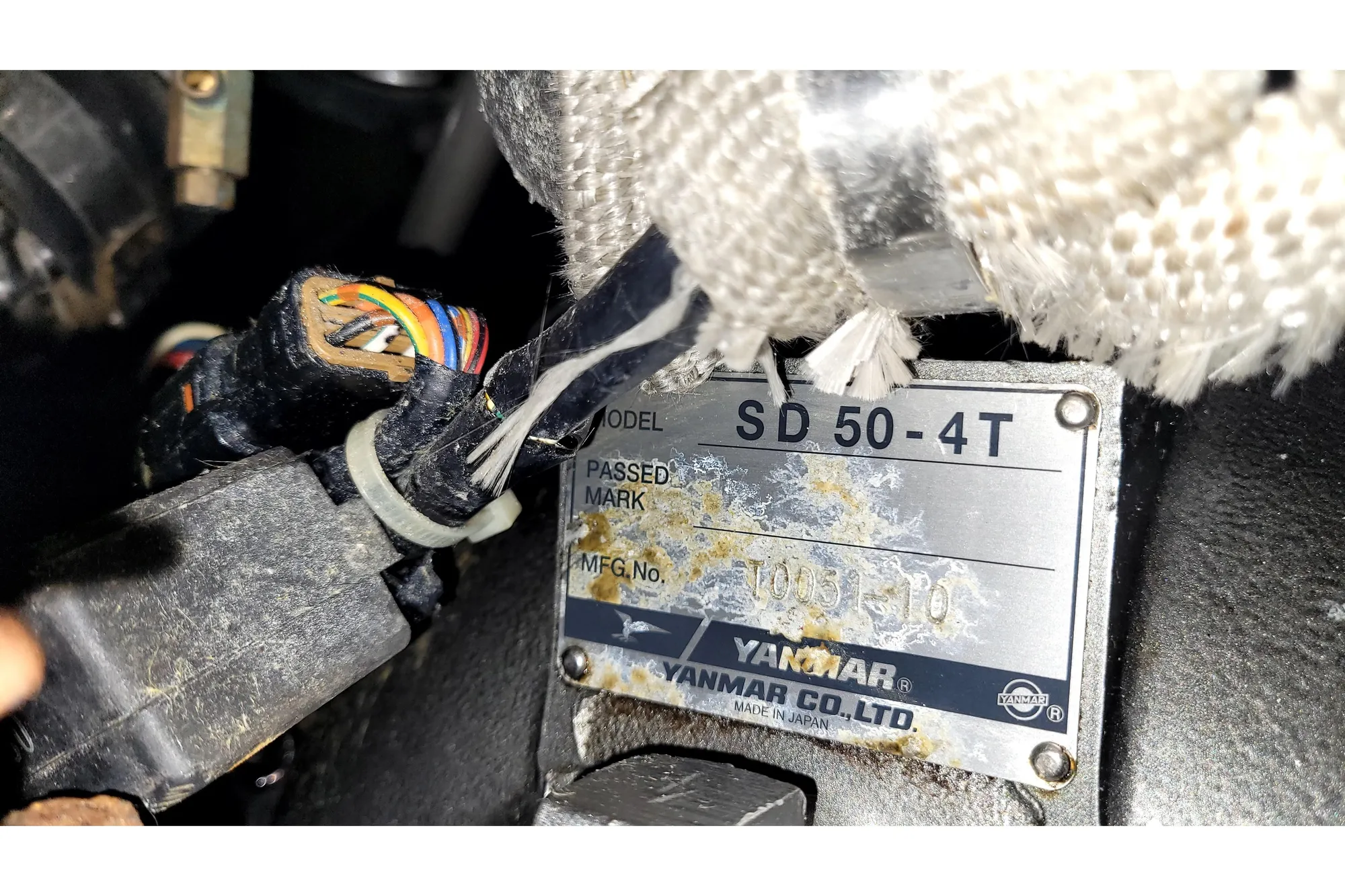 Close-up of Yanmar SD 50-4T engine label with wiring, 2002 International Americas Cup Class.