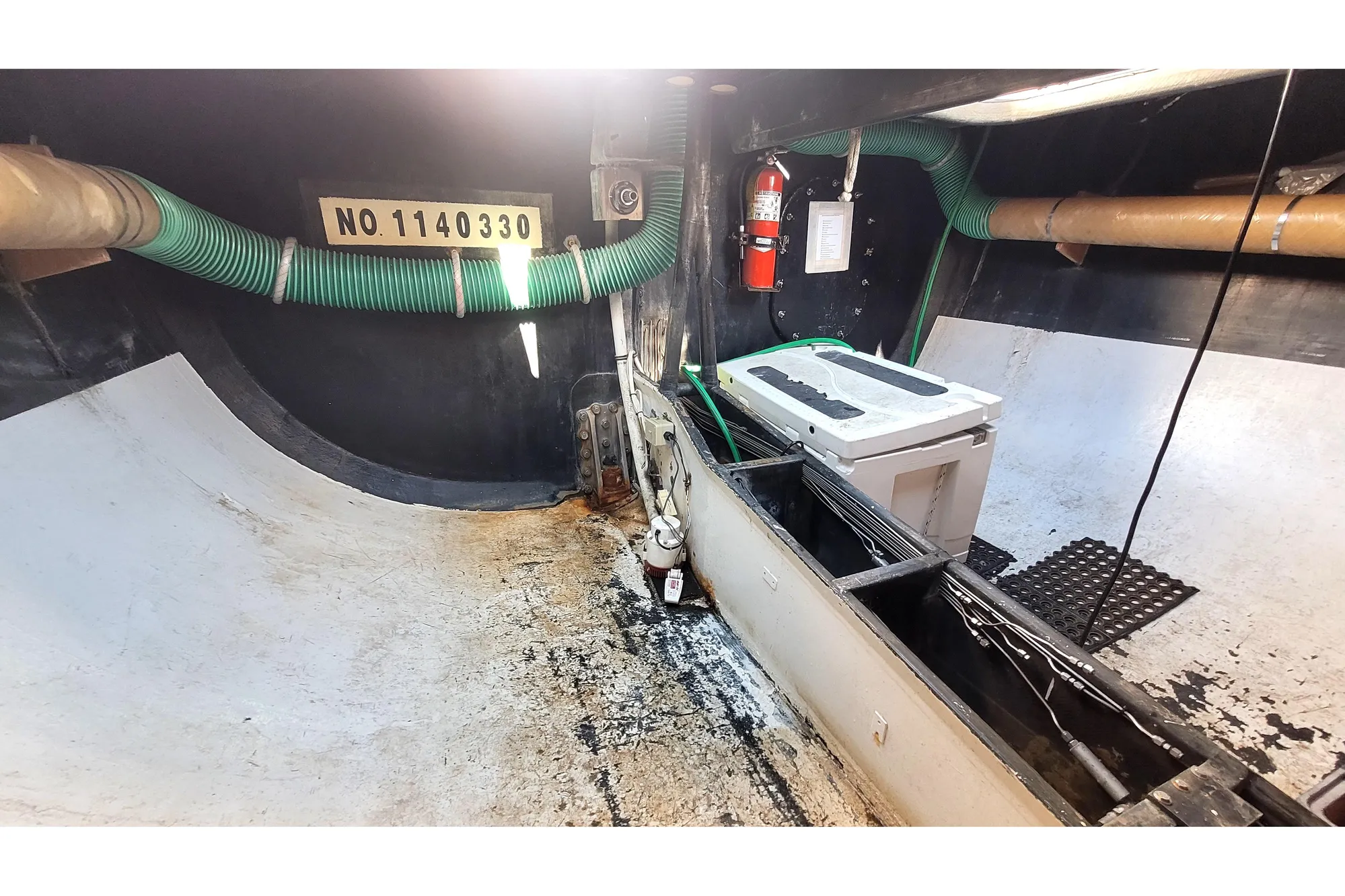 Interior of a 2002 Custom International Americas Cup Class yacht, featuring equipment and storage.