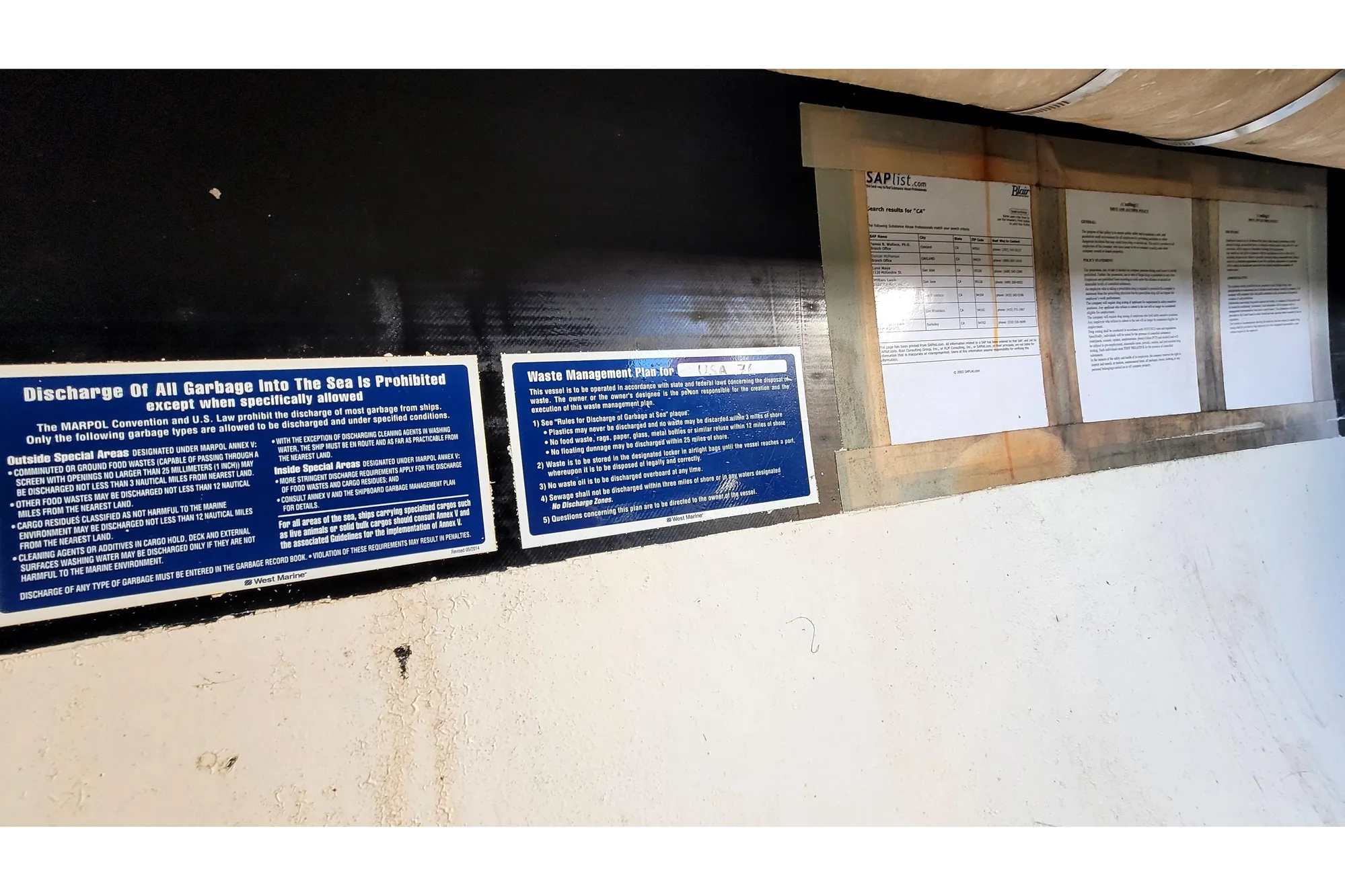 Notices and documents on a 2002 Custom International Americas Cup Class yacht.