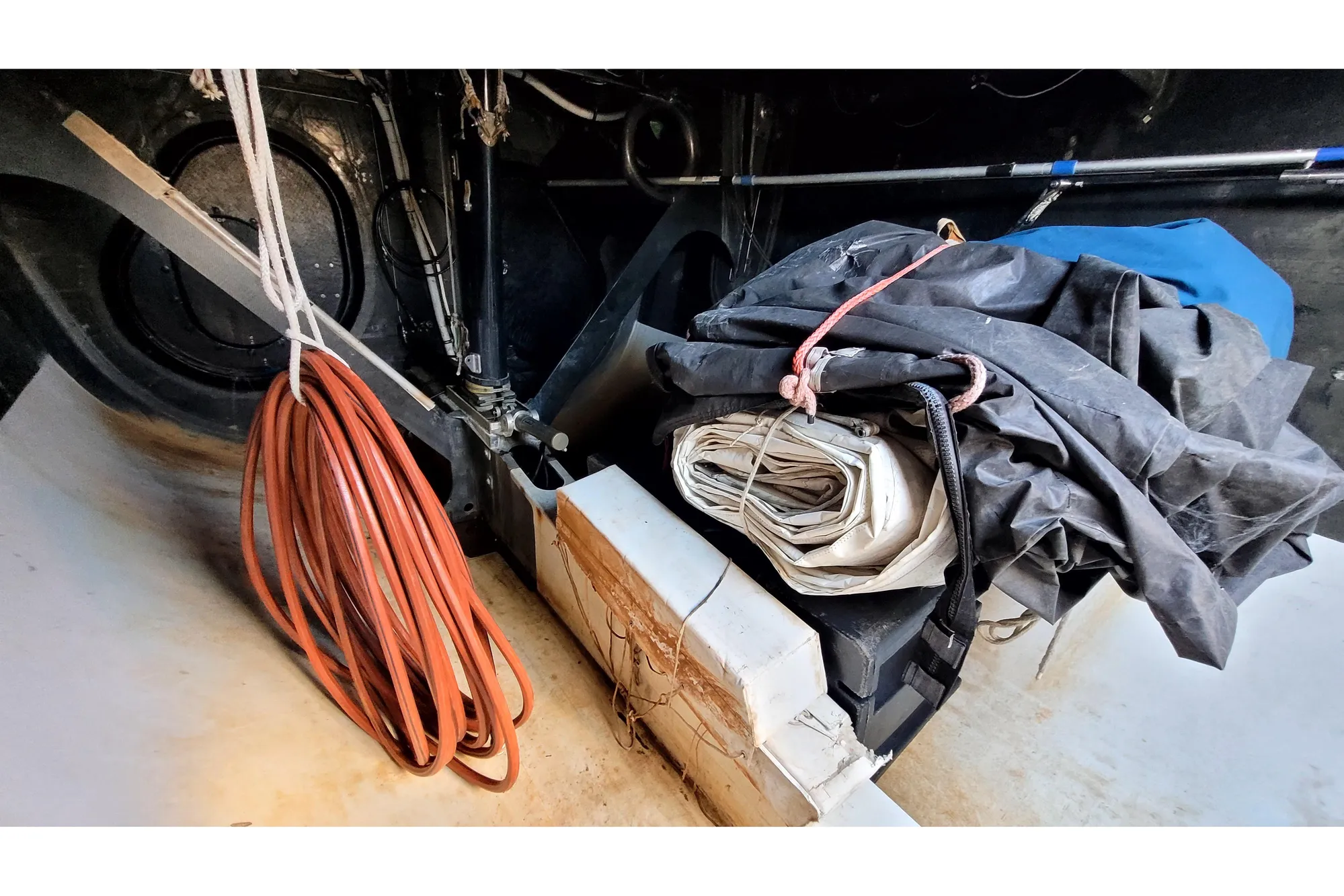 Interior of a 2002 Custom International Americas Cup Class yacht with coiled rope and folded sails.