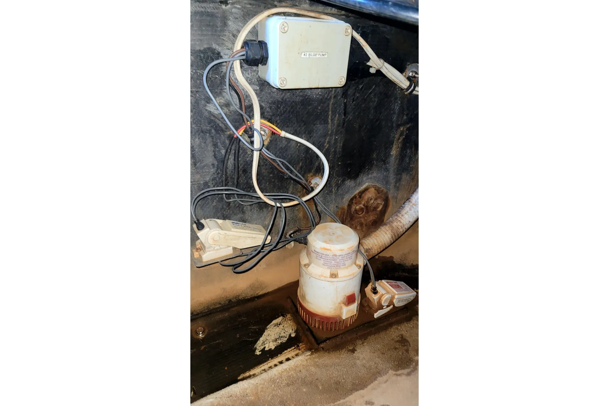 Wiring and pump system inside a 2002 Custom International Americas Cup Class boat.