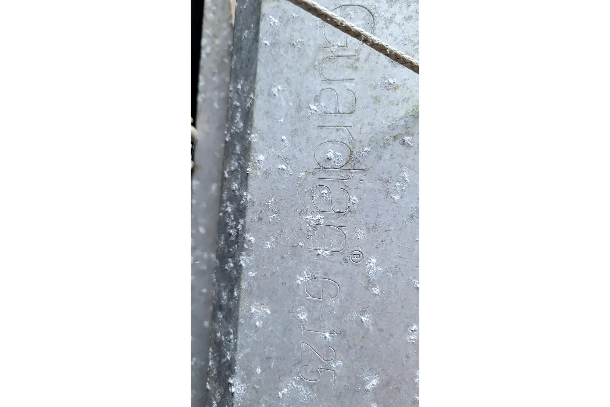 Close-up of textured metal surface with "Guardian G-125" engraving.