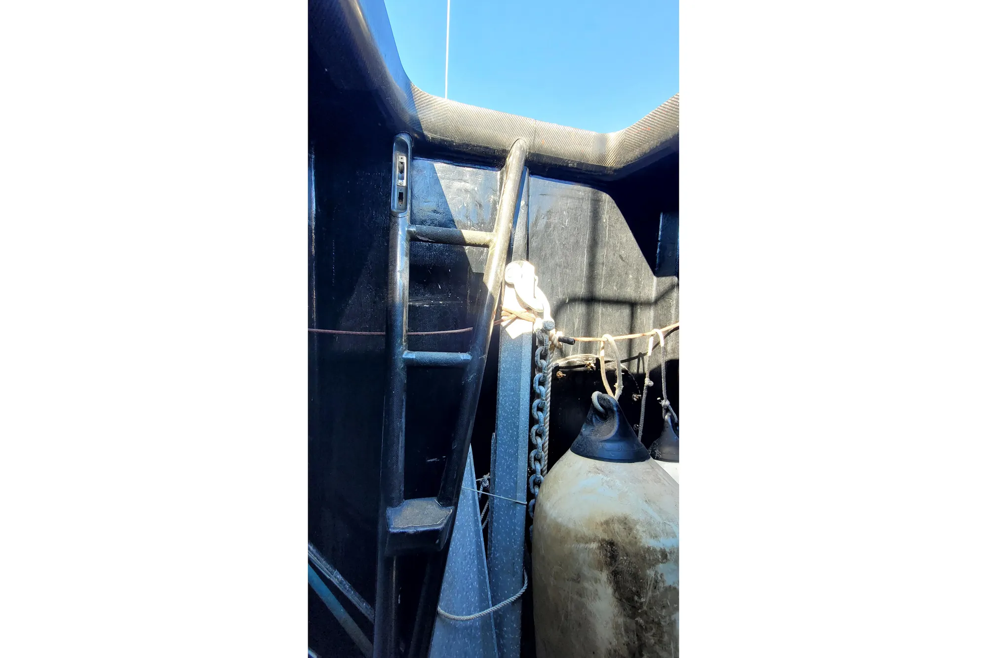 Interior view of a 2002 Custom International Americas Cup Class yacht, featuring equipment and ropes.