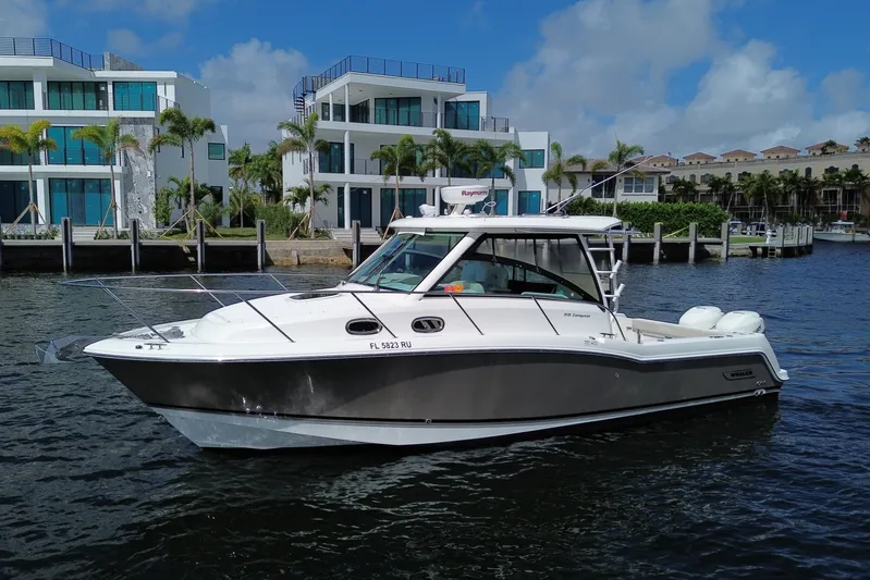  Yacht Photos Pics 2019 Boston Whaler 315 Conquest near modern waterfront homes.