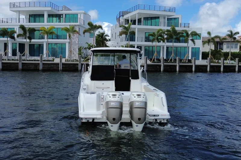  Yacht Photos Pics 2019 Boston Whaler 315 Conquest near modern waterfront villas.