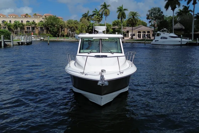  Yacht Photos Pics 2019 Boston Whaler 315 Conquest anchored on calm waters.