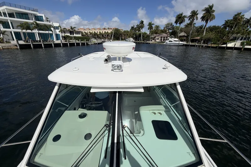  Yacht Photos Pics Boston Whaler 315 Conquest 2019 on water with palm trees in background.