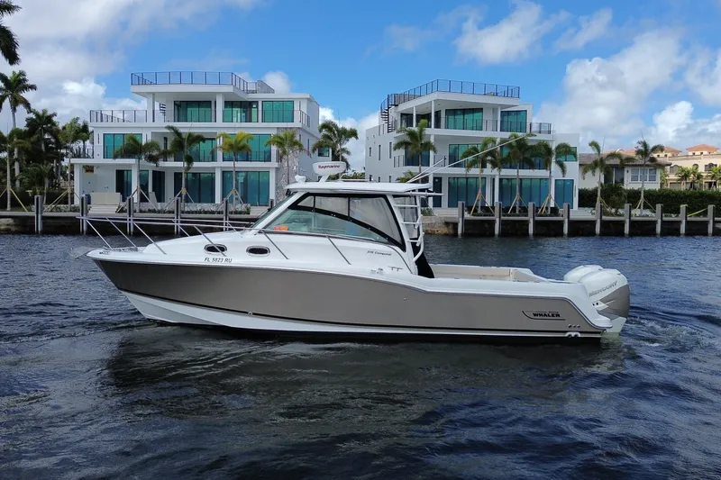  Yacht Photos Pics 2019 Boston Whaler 315 Conquest near modern waterfront villas.